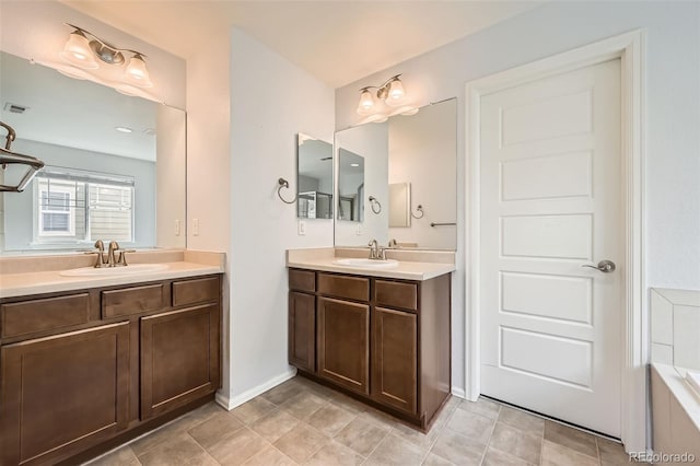 350 N Langdale Ct, Aurora, CO 80018 - full bath with two vanities, baseboards, and a tub to relax in