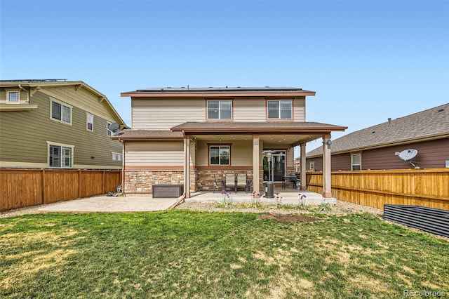 350 N Langdale Ct, Aurora, CO 80018 - rear view of house with a patio, solar panels, and stone siding