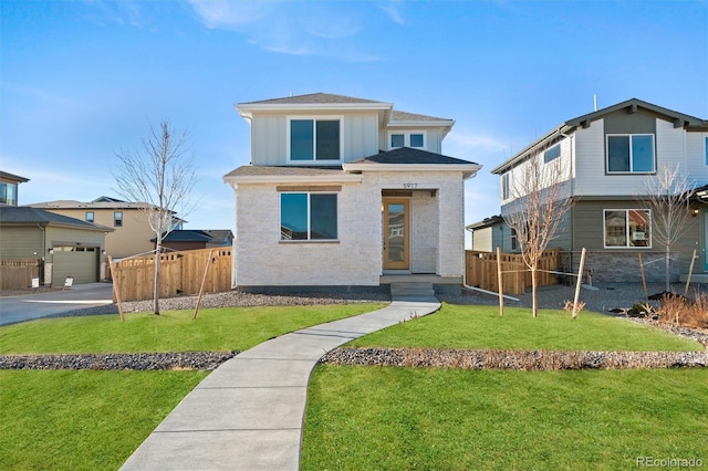 view of front of home with a garage, a shingled roof, a front yard, and fence