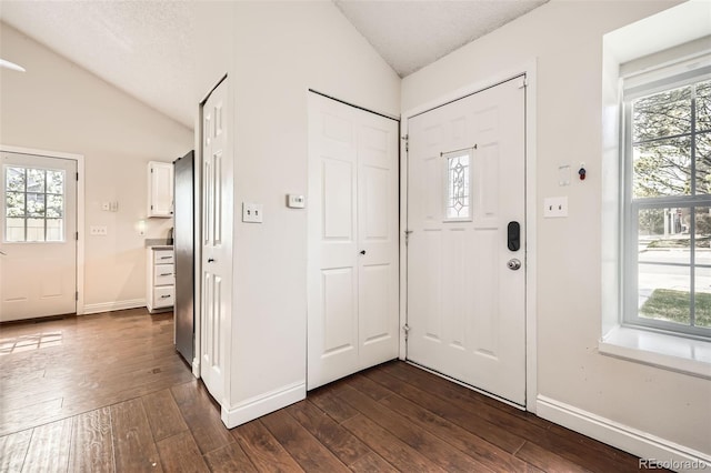 9713 W Chatfield Ave Unit H, Littleton, CO 80128 - entryway featuring vaulted ceiling, dark wood finished floors, and plenty of natural light