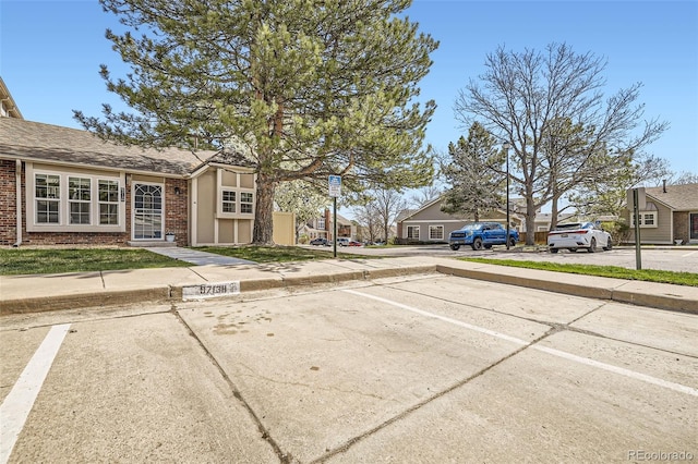 9713 W Chatfield Ave Unit H, Littleton, CO 80128 - view of road featuring sidewalks, curbs, and a residential view