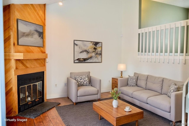 9713 W Chatfield Ave Unit H, Littleton, CO 80128 - living area with wood finished floors and a glass covered fireplace