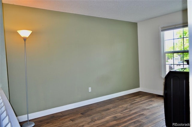 9713 W Chatfield Ave Unit H, Littleton, CO 80128 - spare room with dark wood-style flooring and a textured ceiling