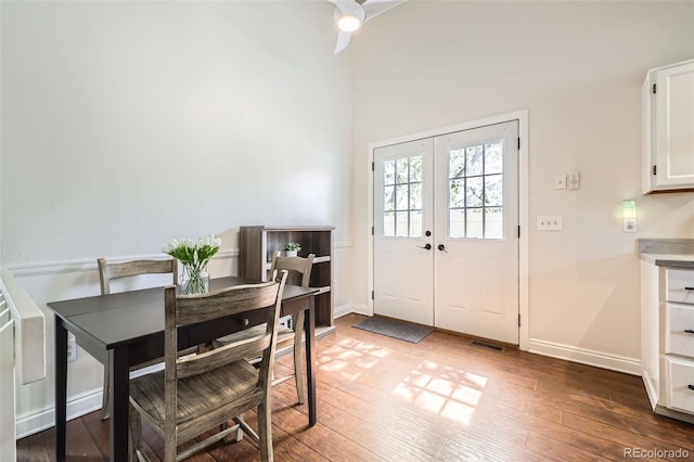 9713 W Chatfield Ave Unit H, Littleton, CO 80128 - dining space featuring wood-type flooring, ceiling fan, and french doors