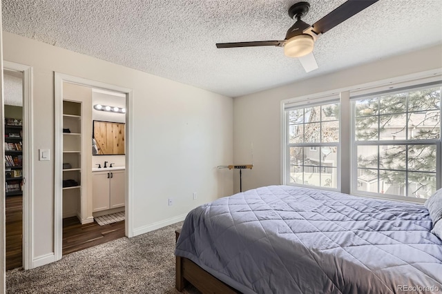9713 W Chatfield Ave Unit H, Littleton, CO 80128 - carpeted bedroom with a textured ceiling, a ceiling fan, and ensuite bath