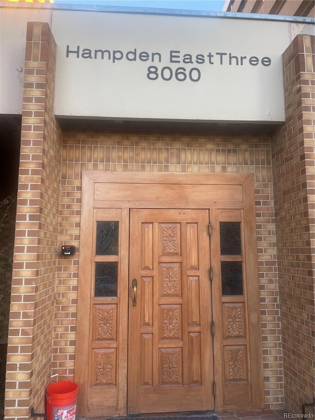 8060 E Girard Ave Unit 504, Denver, CO 80231 - doorway to property featuring brick siding