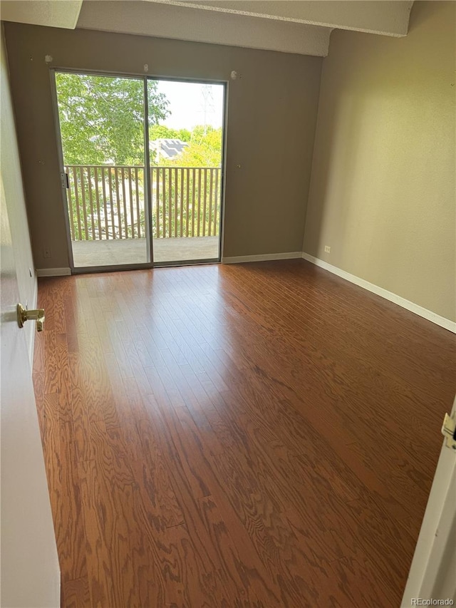 8060 E Girard Ave Unit 504, Denver, CO 80231 - unfurnished room featuring healthy amount of natural light, wood finished floors, and baseboards
