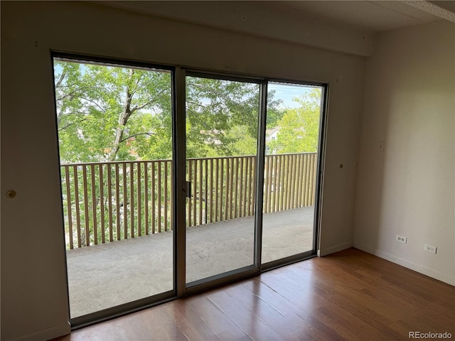 8060 E Girard Ave Unit 504, Denver, CO 80231 - doorway to outside featuring healthy amount of natural light, wood finished floors, and baseboards