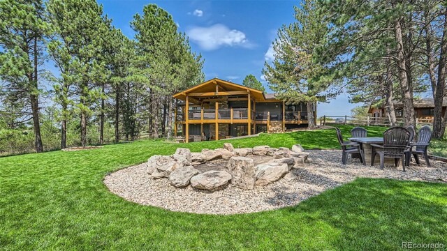 2231 Meadow Green Cir, Franktown, CO 80116 - back of house featuring a fire pit and a wooden deck