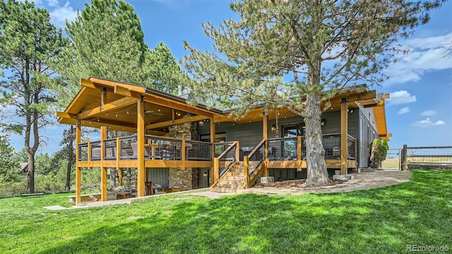 2231 Meadow Green Cir, Franktown, CO 80116 - rear view of house with stone siding, a deck, and stairs