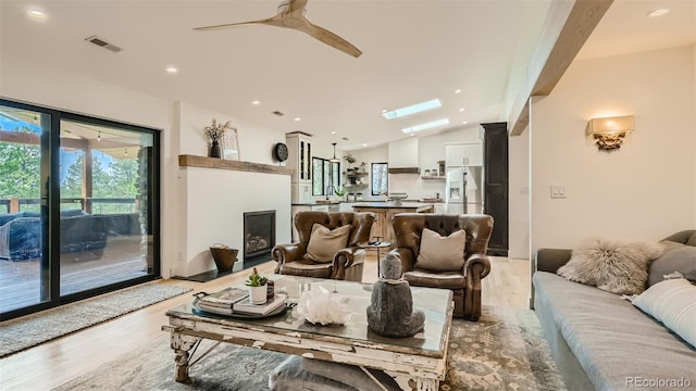2231 Meadow Green Cir, Franktown, CO 80116 - living area with vaulted ceiling, light wood-style floors, a ceiling fan, and recessed lighting