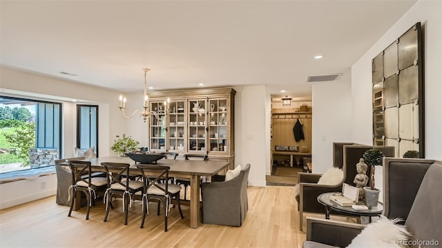 2231 Meadow Green Cir, Franktown, CO 80116 - dining room featuring light wood-style floors, a chandelier, and recessed lighting
