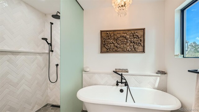 2231 Meadow Green Cir, Franktown, CO 80116 - bathroom with a freestanding tub, a tile shower, and a chandelier