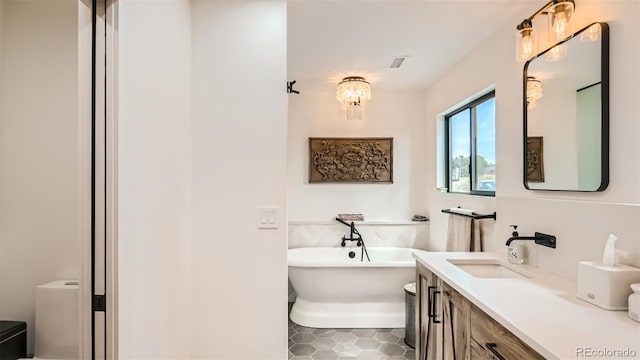 2231 Meadow Green Cir, Franktown, CO 80116 - full bathroom with a soaking tub, vanity, tile patterned flooring, and a chandelier