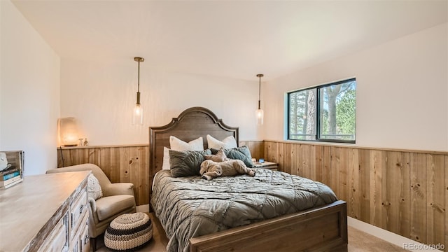 2231 Meadow Green Cir, Franktown, CO 80116 - bedroom with wooden walls, wainscoting, and light carpet