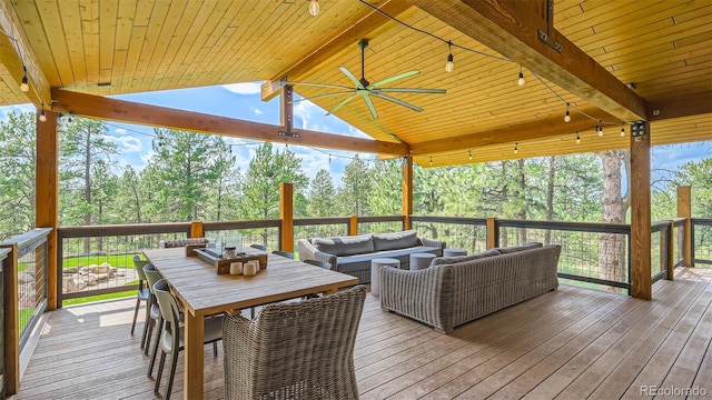 2231 Meadow Green Cir, Franktown, CO 80116 - wooden terrace featuring outdoor lounge area, view of wooded area, and a ceiling fan