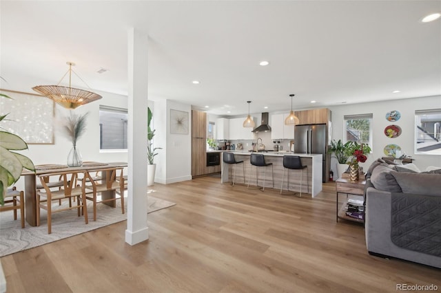 living room with sink and light wood-type flooring