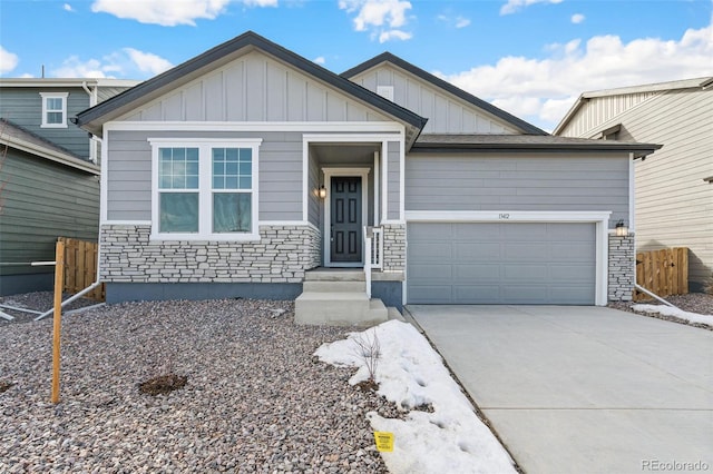 13412 E 110th Way, Commerce City, CO 80022 - view of front facade featuring stone siding, board and batten siding, a garage, and concrete driveway