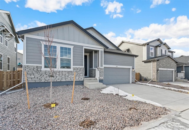 13412 E 110th Way, Commerce City, CO 80022 - view of front of home with board and batten siding, a garage, driveway, and stone siding
