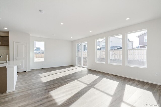 13412 E 110th Way, Commerce City, CO 80022 - unfurnished living room with light wood finished floors and recessed lighting