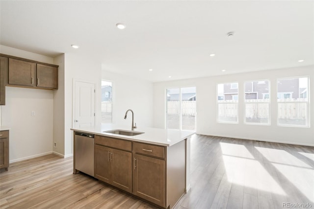 13412 E 110th Way, Commerce City, CO 80022 - kitchen featuring dishwasher, light wood-type flooring, a center island with sink, light countertops, and open floor plan