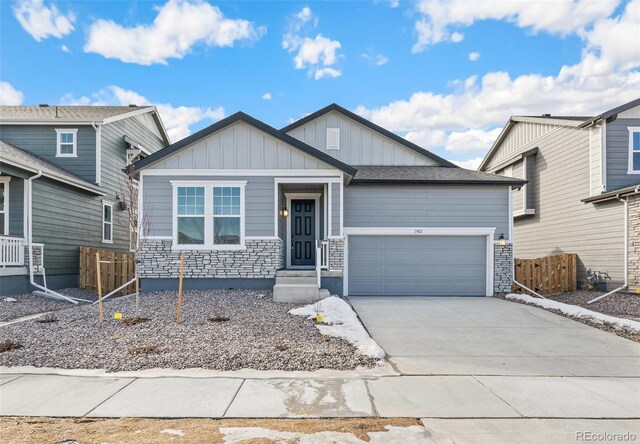 13412 E 110th Way, Commerce City, CO 80022 - craftsman-style home featuring a garage, board and batten siding, driveway, and stone siding