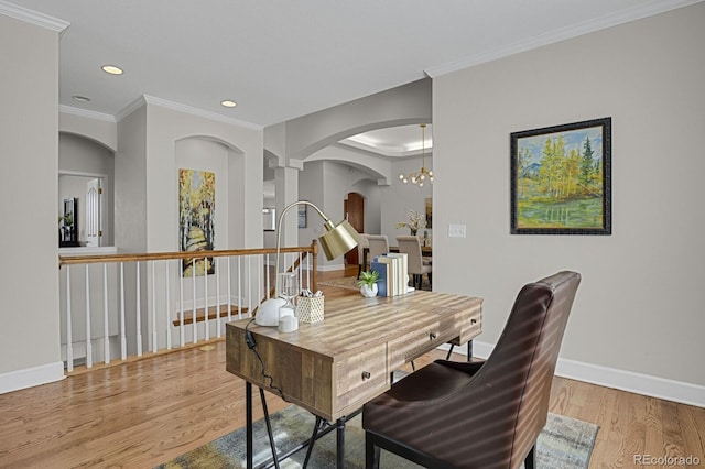 dining area with hardwood / wood-style flooring, ornamental molding, and an inviting chandelier