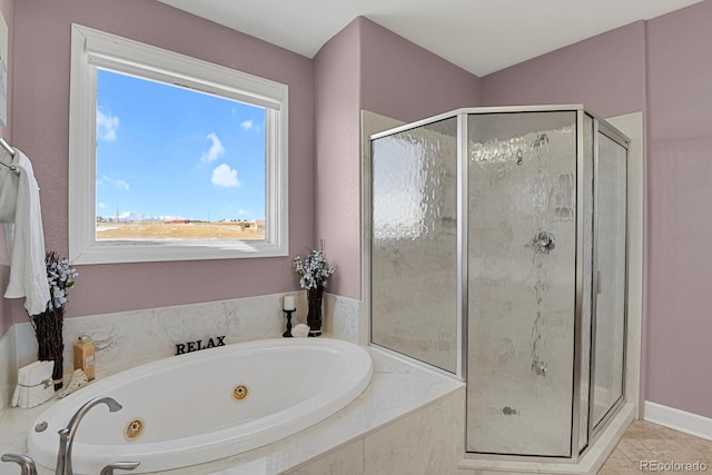 bathroom with a stall shower, tile patterned flooring, and a whirlpool tub