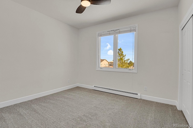 unfurnished bedroom with a baseboard heating unit, carpet floors, a ceiling fan, baseboards, and a closet