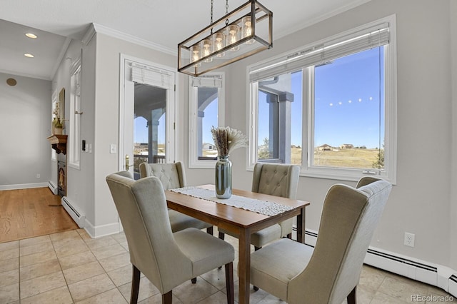 dining area with a wealth of natural light, light hardwood / wood-style flooring, a baseboard radiator, and ornamental molding