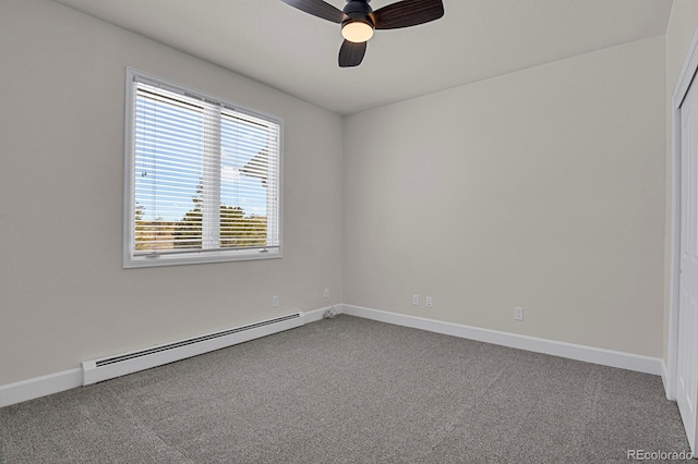 carpeted spare room with ceiling fan and a baseboard heating unit