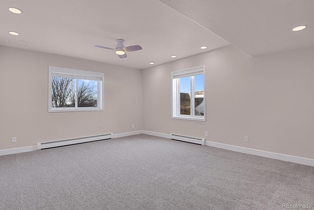 spare room with carpet floors, a baseboard radiator, and baseboards