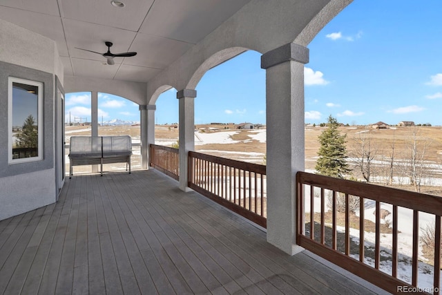 wooden deck featuring ceiling fan