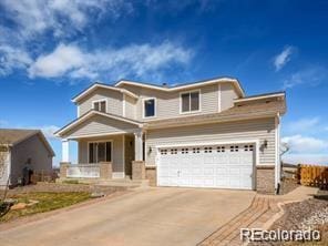 view of front of home featuring concrete driveway, a garage, and fence