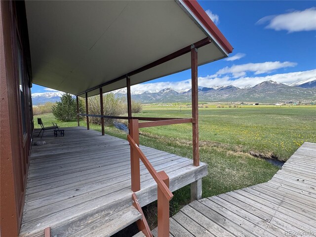 700 County Road 150, Westcliffe, CO 81252 - wooden terrace with a mountain view, a yard, and a rural view