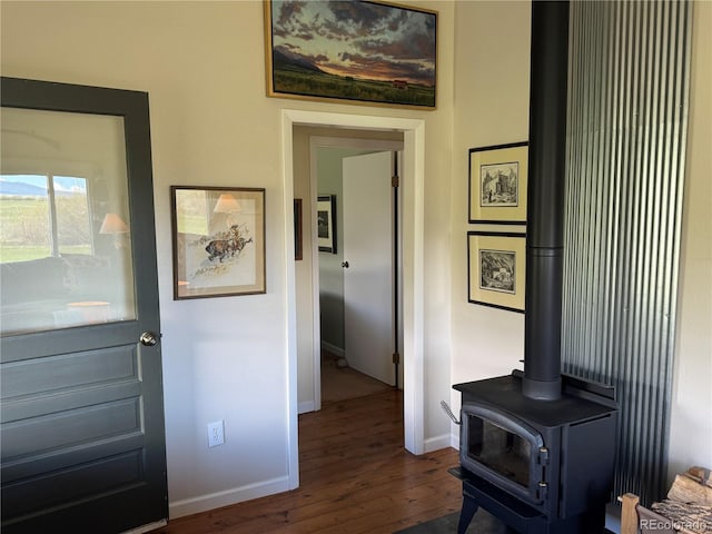 700 County Road 150, Westcliffe, CO 81252 - foyer entrance with dark wood-style flooring, a wood stove, and baseboards