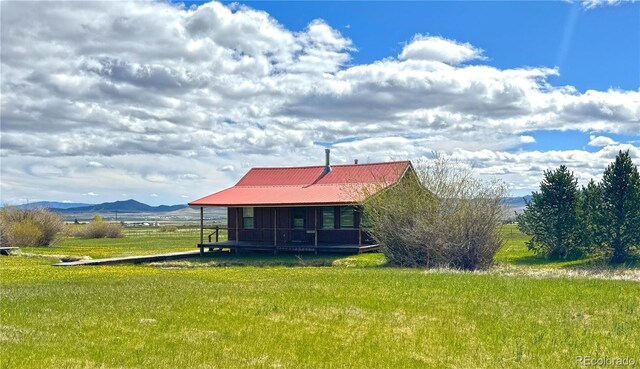 700 County Road 150, Westcliffe, CO 81252 - back of property with a yard, metal roof, and a mountain view