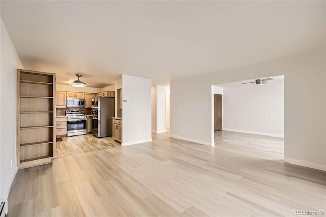 unfurnished living room featuring baseboards, ceiling fan, and light wood finished floors