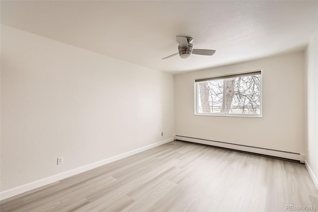 unfurnished room featuring a baseboard radiator, baseboards, ceiling fan, and light wood finished floors