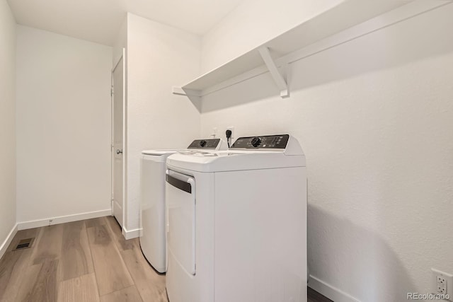 15276 Fillmore St, Thornton, CO 80602 - laundry room with washer and dryer, light wood-type flooring, and baseboards