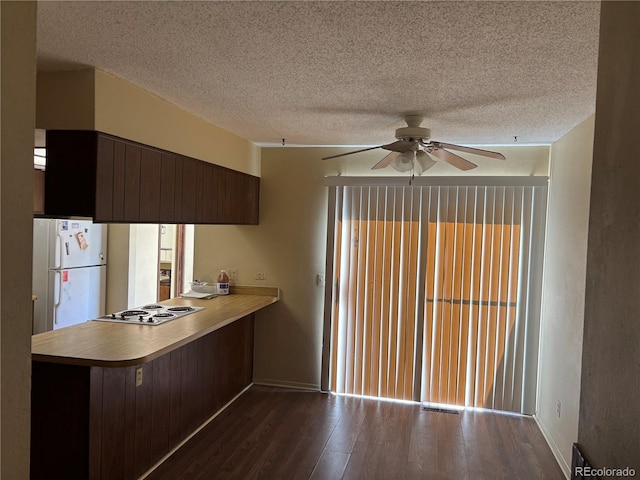 1967 S Oakland Way, Aurora, CO 80014 - kitchen featuring freestanding refrigerator, stainless steel electric cooktop, a ceiling fan, dark wood finished floors, and a peninsula