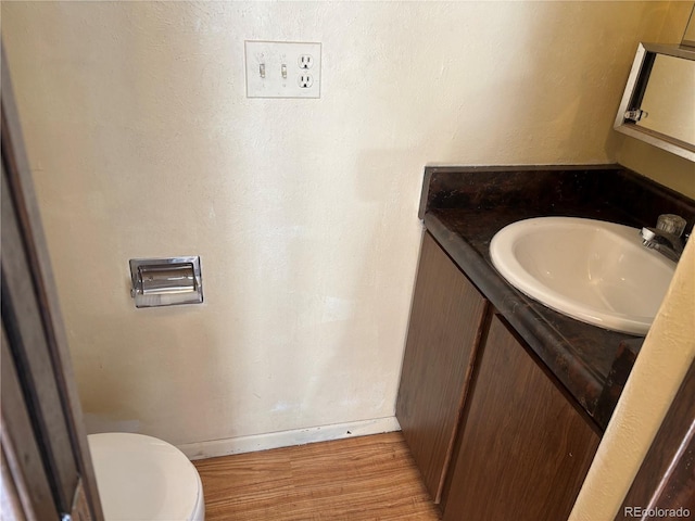 1967 S Oakland Way, Aurora, CO 80014 - half bath with vanity, toilet, wood finished floors, and baseboards