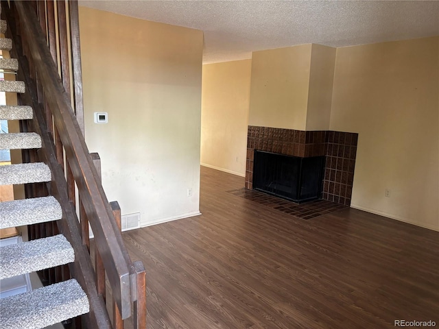 1967 S Oakland Way, Aurora, CO 80014 - unfurnished living room with wood finished floors, stairway, a textured ceiling, and baseboards