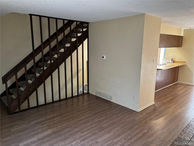 1967 S Oakland Way, Aurora, CO 80014 - stairway with a textured ceiling, wood finished floors, and baseboards