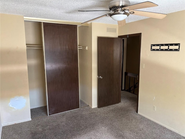 1967 S Oakland Way, Aurora, CO 80014 - unfurnished bedroom featuring carpet flooring, a textured ceiling, a closet, baseboards, and a ceiling fan