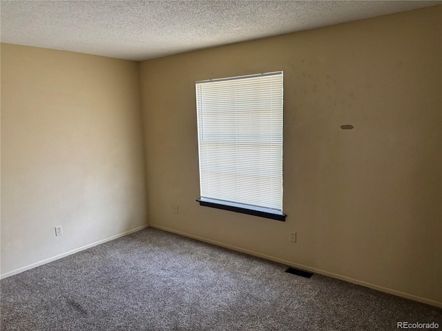 1967 S Oakland Way, Aurora, CO 80014 - carpeted spare room featuring a textured ceiling and baseboards