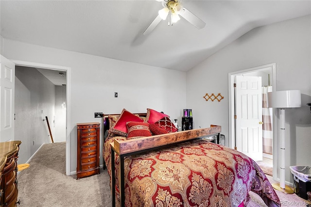 bedroom with vaulted ceiling, light carpet, and a ceiling fan