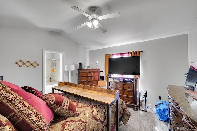 bedroom with a ceiling fan, light carpet, vaulted ceiling, ensuite bath, and baseboards