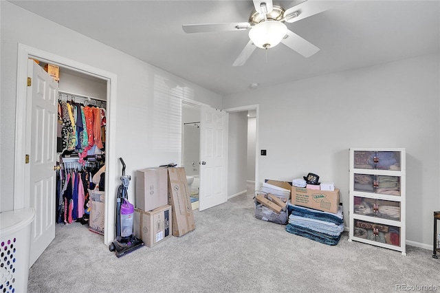 interior space featuring carpet floors, ceiling fan, a spacious closet, and a closet