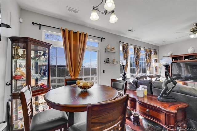 dining area with visible vents and ceiling fan with notable chandelier